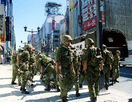 Camouflaged GSDF troops do drills in Ginza